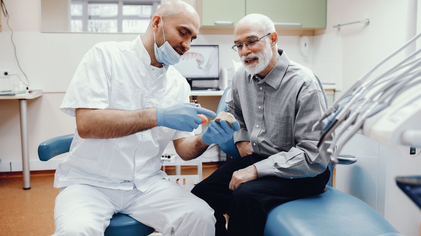 Dentist With The Patient At The Dental Clinic