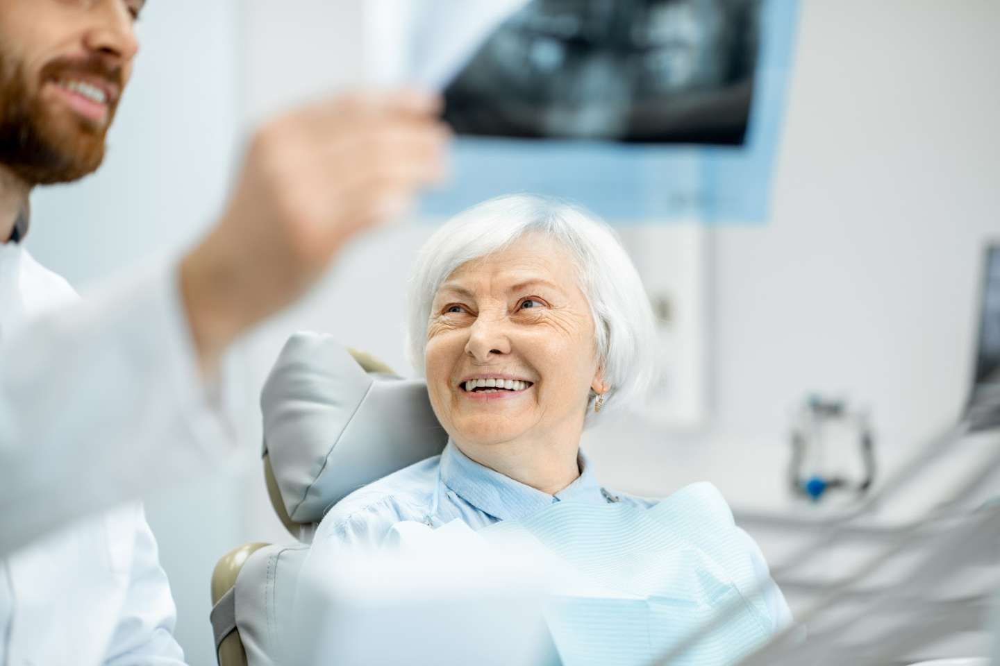 Dentist Showing Dental X-ray To The Patient