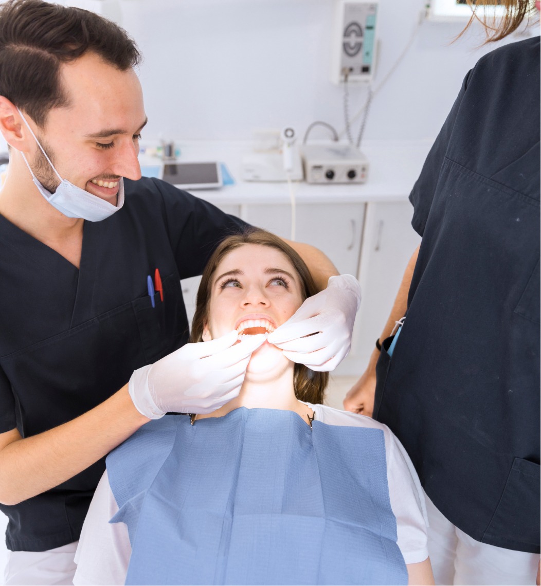 Dentist Examining A Patient's Teeth