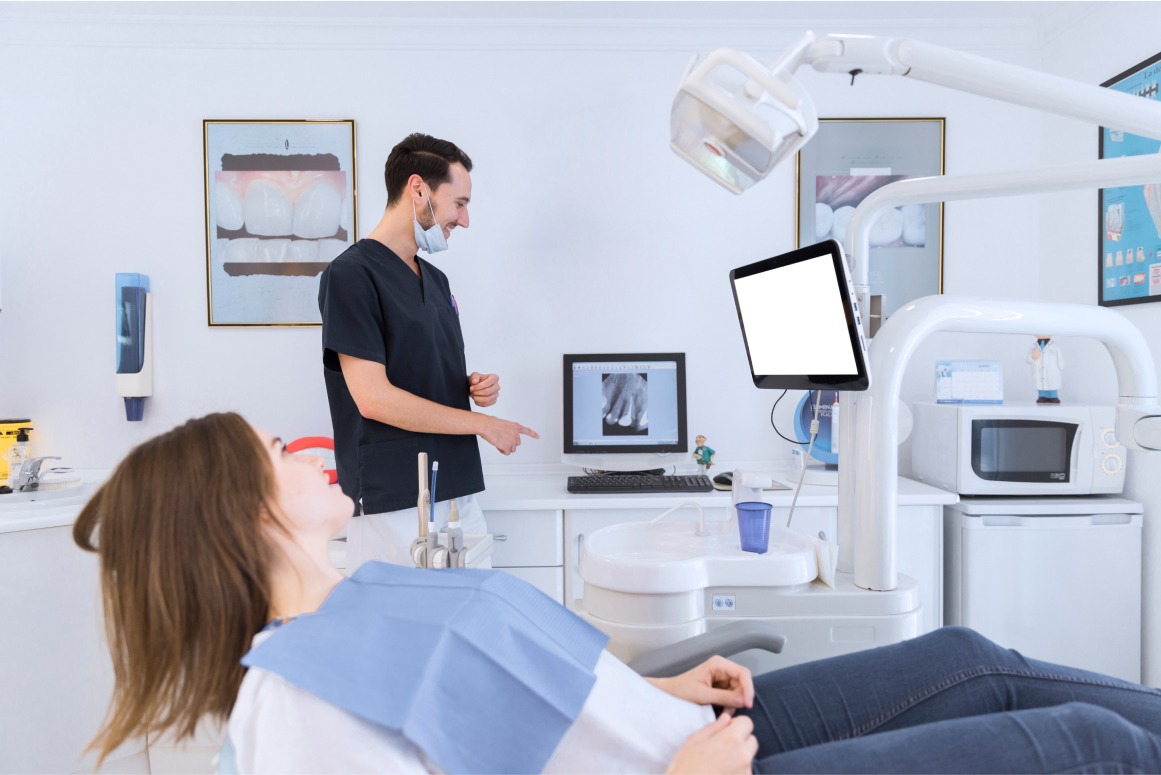Dentist Reviewing Patients X-ray On Screen